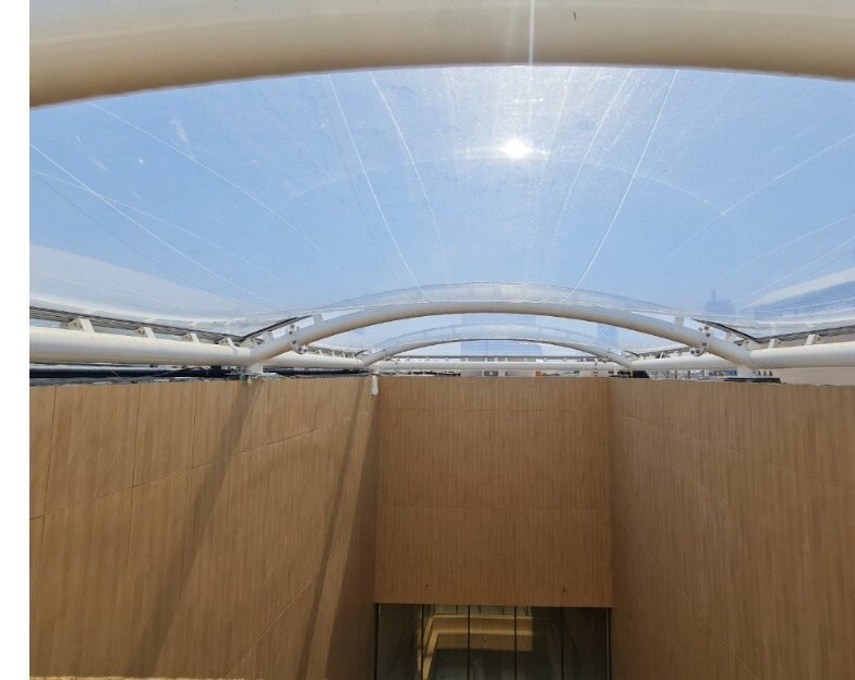 Double-layer ETFE cushion roof at MACHS in Dammam seen from below, sunlight diffusing through the inflated panels